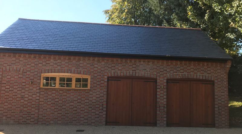 Brick double garage with oak doors and a new slate roof