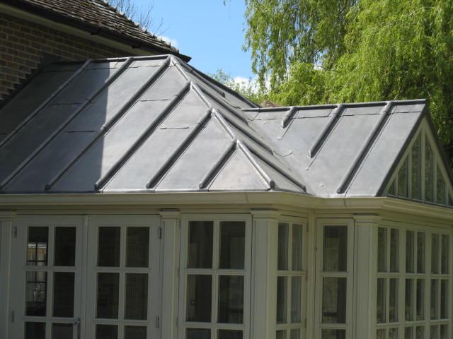 Leaded conservatory roof with hip and wood-roll detailing